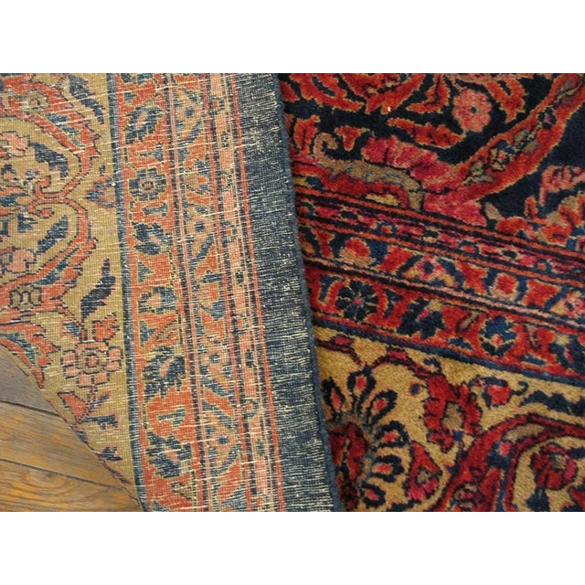 This is an extremely densely patterned circa 1920 high quality Sarouk whose swirling, thick red arabesques and attendant...