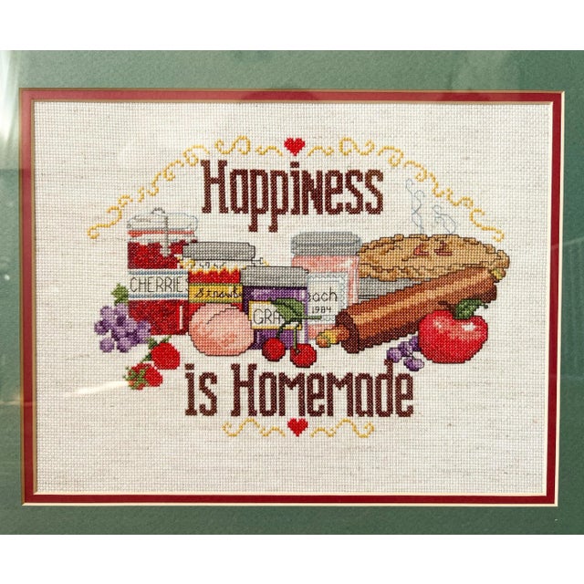 Inviting and colorful cross stitch crafted in 1984. Features the saying "Happiness is Homemade" and is embellished with...
