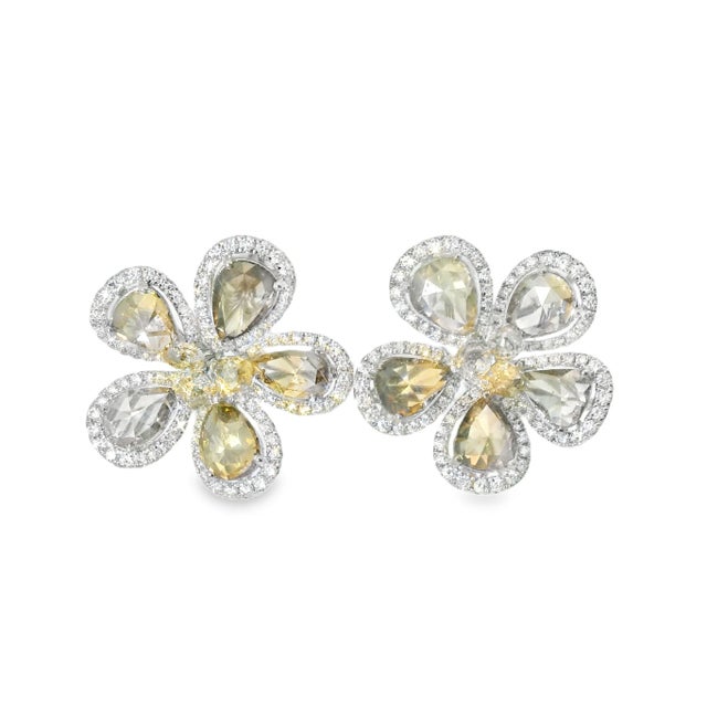 18K white gold earrings with 5 pear-shaped rose cut champagne diamonds, 3 smaller champagne diamonds at the center, and...