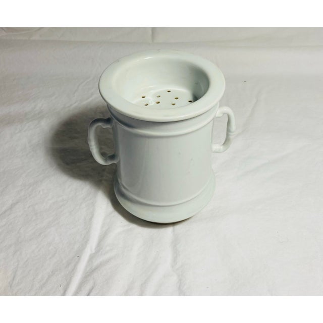 Antique porcelain mug with dual handle with strainer for coffee or tea grounds perhaps for outdoor camp usage