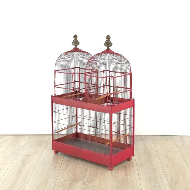 An early 20th-century red painted birdcage, England circa 1920.