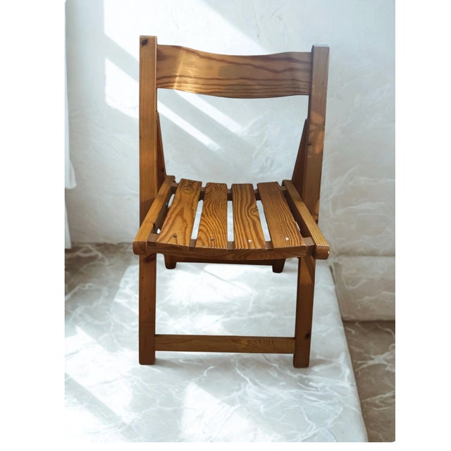 An exceptional pair of Mid-Century Modern folding chairs, masterfully crafted from solid Scandinavian pine wood during the...