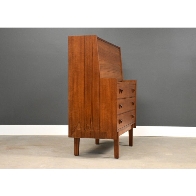 A mid century modern teak secretary desk. Made in Denmark. Circa 1960’s. Excellent condition. Writing surface height is...