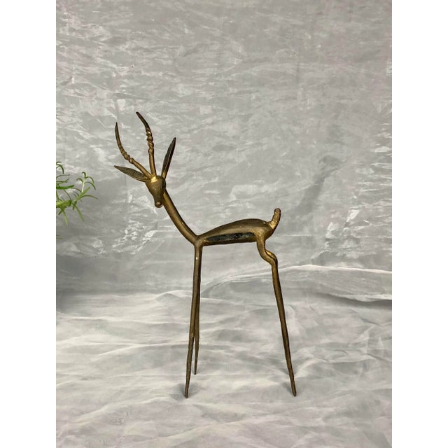 This vintage African bronze gazelle sculpture would make an interesting home decor accent on a living room shelf or entry...