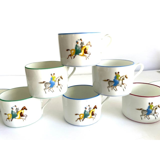 This is a group of ten items-- four saucers and six tea cups ( or coffee/espresso). The equestrian motif depicts a couple...
