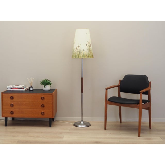 The lamp was made in the 1970s, Danish production. Made of teak wood and metal. Lampshade covered with yellow plastic....