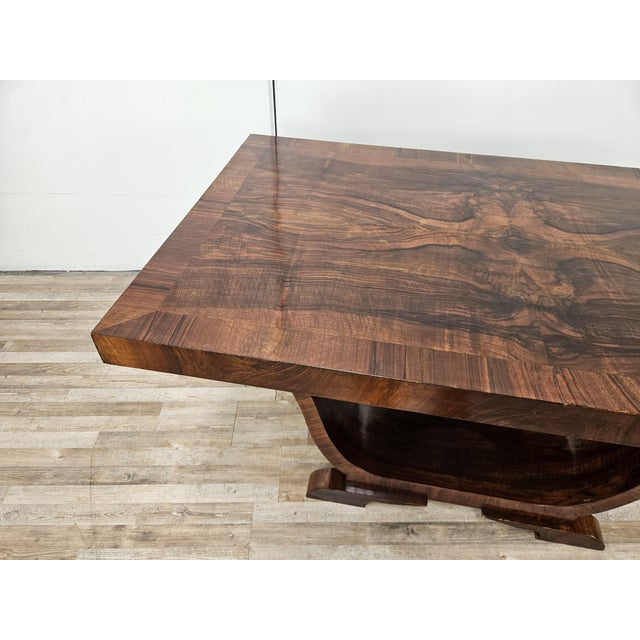 An elegant Art Deco dining or reception table dating back to the 1940s, this table features a strong sculptural presence...