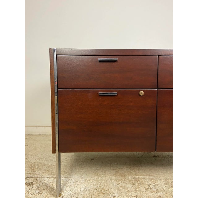This gorgeous walnut (with a mahogany finish) and stainless polished chrome credenza made by Stow Davis is extemely well...