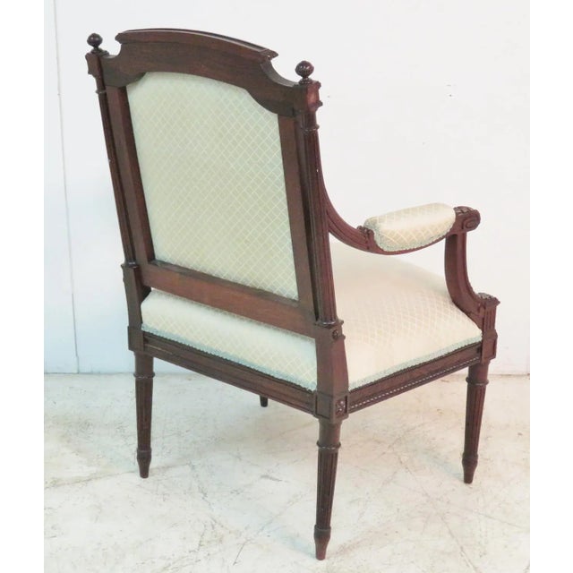 Rosewood carved frame. Decorative cream upholstery. This item includes restricted materials and can not be sold outside of...