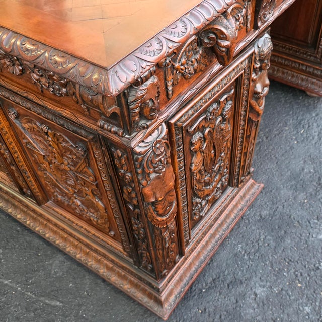 An exceptional and monumental French Renaissance Revival partner's desk crafted in richly figured walnut, circa 1900....