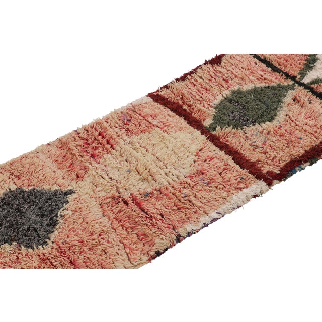 Handwoven in wool and originating from Morocco circa 1950-1960, this 2x7 vintage runner rug is a rare and among the most...