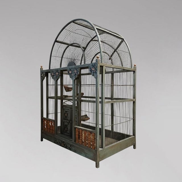 Impressive large birdcage, decorative with two wooden doors and a turned gallery; the woodwork is adorned with painted...