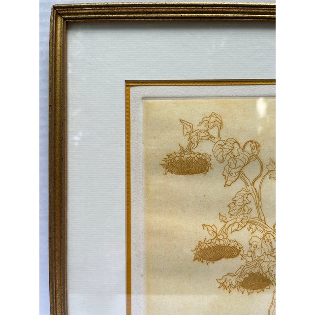 A single print featuring a drooping sunflower with tone on tone yellow coloring. Finished with glass, gold wood frame, and...
