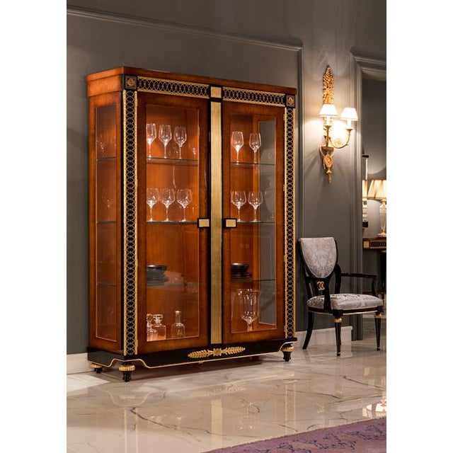 Handcrafted in Spain, this china cabinet features oak burl veneer with sycamore inlays, ebony accents, and bronze trim...