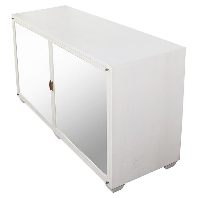 A striking white painted wood sideboard by Julian Chichester, blending classic elegance with contemporary flair. The piece...