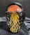Striking Murano-style blown art glass paperweight featuring a vibrant jellyfish design in rich orange, yellow, and black...