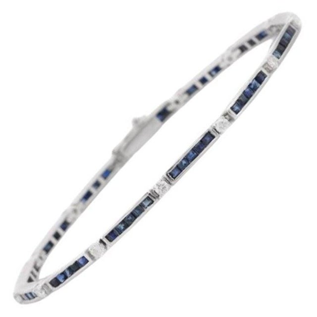 Enhance your jewelry collection with this sleek and sophisticated Blue Sapphire Tennis Bracelet, beautifully handcrafted...