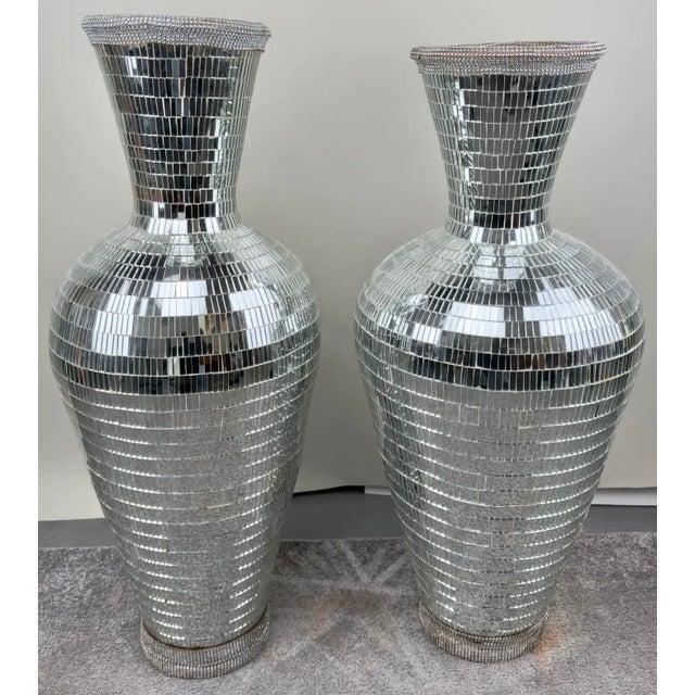 Experience grandeur with this luxurious pair of handmade Monumental Art Deco Style Micro Mosaic Mirrored Over Clay Urns....