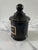 A vintage black glass apothecary jar from Jean Vivaudou Co. Inc, originally holding Orloff Bergamot Men's Bath Talc. The...