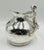 A whimsical and sculptural silver-plated water pitcher designed and handcrafted in Taxco, Mexico by celebrated artist...