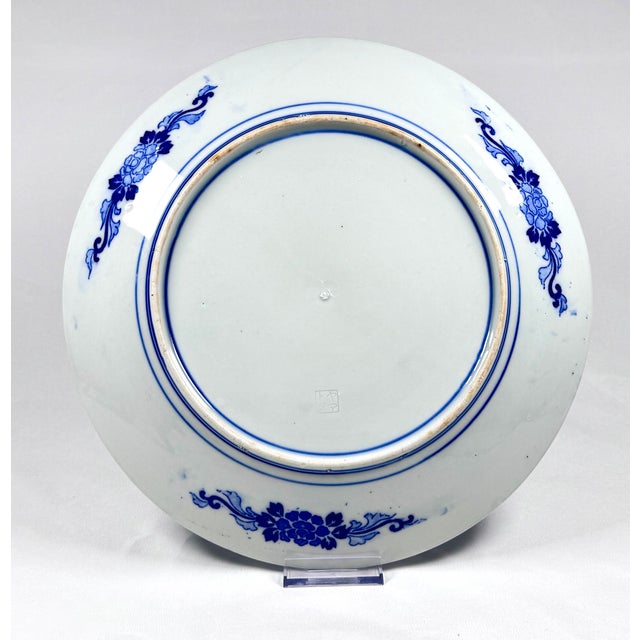 An antique Japanese decorative porcelain charger with rich blue-and-white decoration, believed to date to the early 20th...