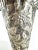 A finely detailed vintage European silverplate vase featuring repoussé floral and foliate motifs in high relief, set on a...