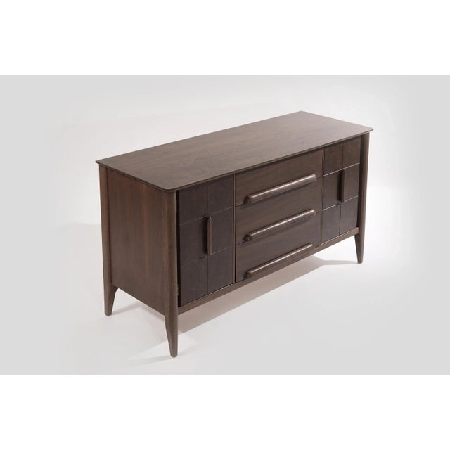 A petite Mid-Century Modern credenza by Stanley Furniture, featuring walnut burl doors showcasing gorgeous grain, the...