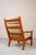 This high-backed armchair by Juul Kristensen is an inviting chair for reading and relaxing. The warm color of the teak...