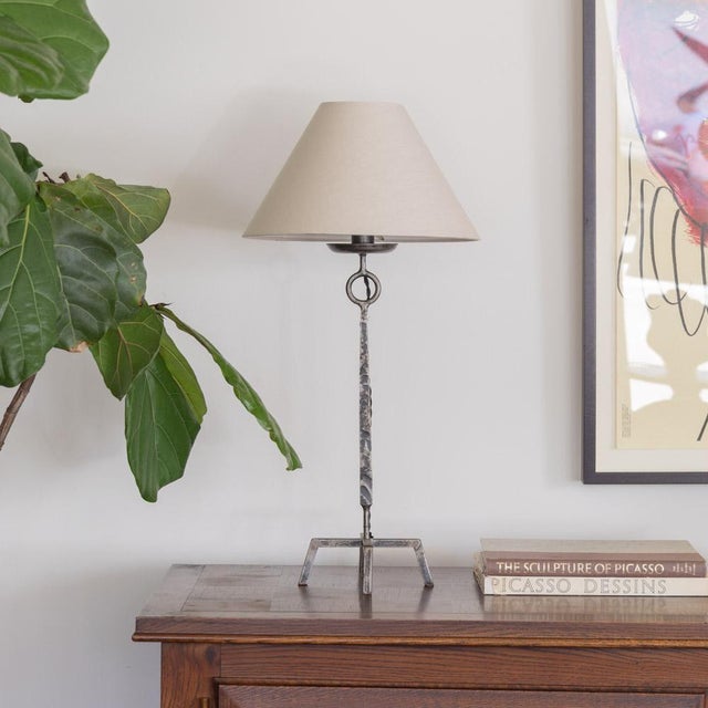 Beautiful iron Brutalist table lamp from France, 1930s. Iron body with circle detail and four angled iron feet. Newly re-...