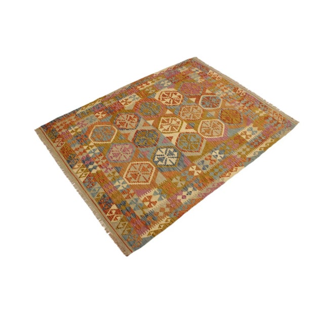Add a touch of elegance to your home with this casual chic hand woven Tribal Kilim wool rug. Constructed on a loom by...