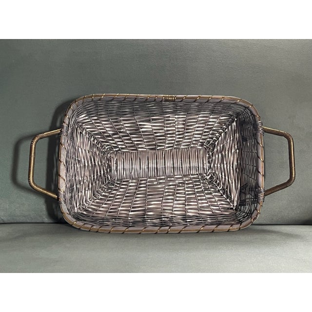 A classic metallic long rectangular basket for display or use.