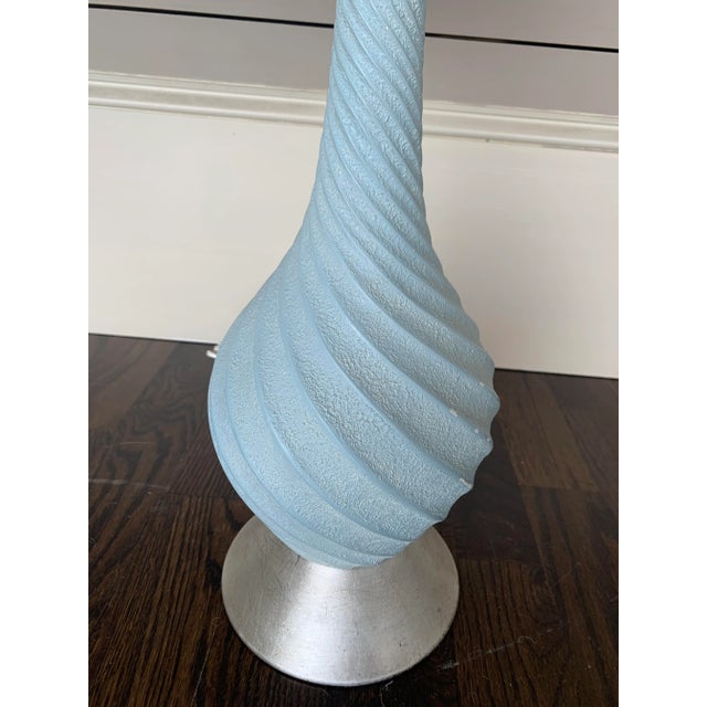 Mid Century lamp with blue finish and silver leaf base. Lucite finial.