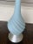 Mid Century lamp with blue finish and silver leaf base. Lucite finial.