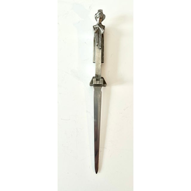 Spectacular and very unique letter opener. Silver plate or Pewter, however it's the design that makes the piece so great....