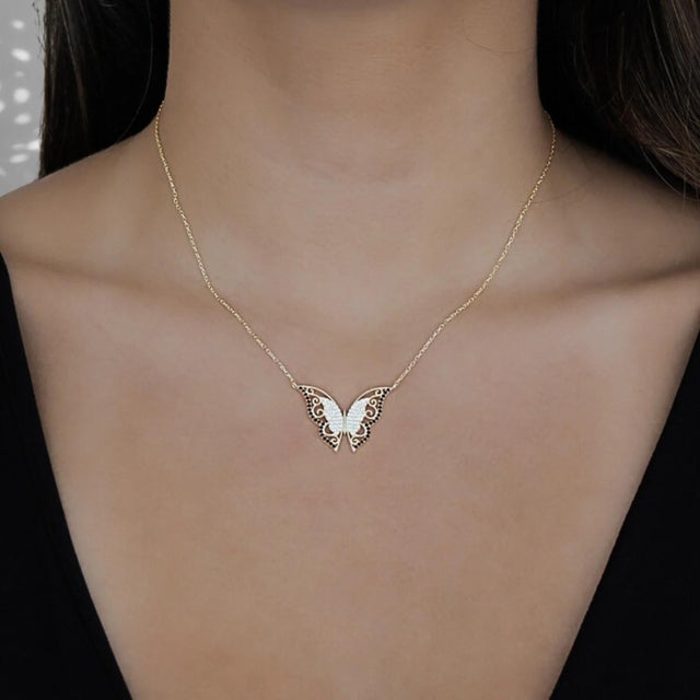 The New Beginning Gold & Black Diamond Butterfly Pendant Necklace, a dazzling piece of jewelry that radiates joy, beauty,...