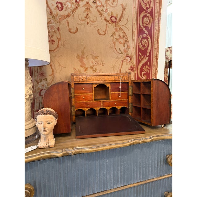 This remarkably engineered antique English stationary cabinet doubles as a portable writing or campaign desk. The exterior...
