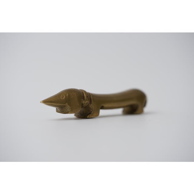 Object: Bottle opener in the shape of a dachshund Designer: Walter Bosse (1904–1979) Age: 1950s/1960s Material: Brass...