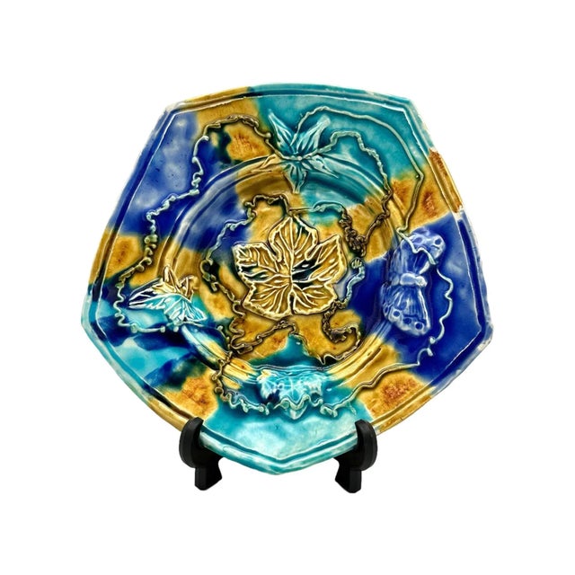 This handmade decorative plate is a unique addition to any collection. The geometric shape and vibrant yellow and blue...