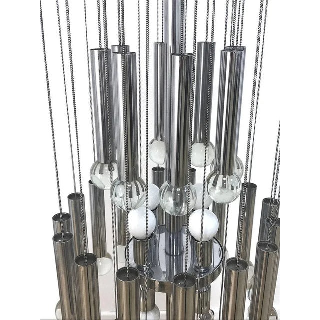 Beautiful chandelier from the 70s by Gaetano Sciolari. The chromed structure supports 32 chains with chrome tubes and...