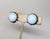 1950s round goldtone prong set single cabochon faux-moonstone with goldtone loops around the edges butterfly clip back...