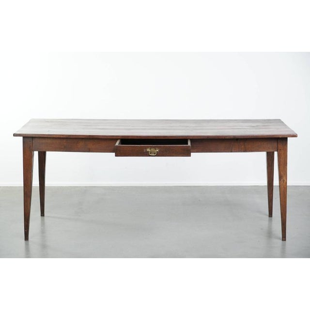 This unique antique early 19th-century English oak farmhouse dining table is suitable for easily seating 6 to 8 people...