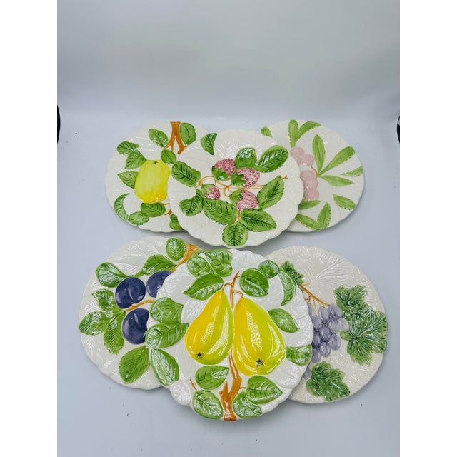 This is a vibrant set of Italian hand-painted ceramic fruit plates, each crafted with lively relief textures and bold,...