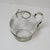 Delightful, round transparent glass pitcher featuring frosted star and circle motifs.