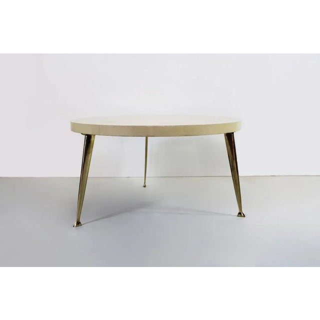 Elegant round table coffee with plane entirely in parchment and brass legs. Dimensions: Diam: 76 cm H: 43 cm Origin: Italy...