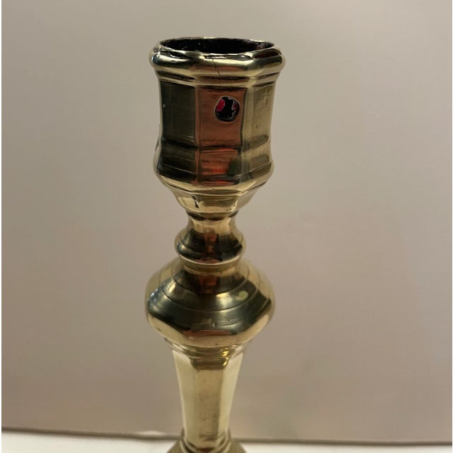 Large French brass candlestick circa 1700-1720, octagonal baluster form with a wide base and paneled candle cup with round...