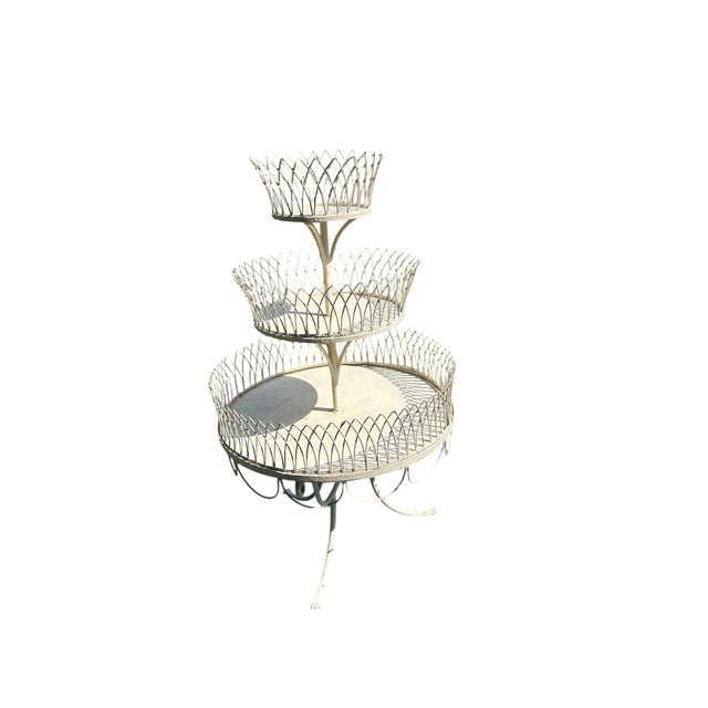 This piece is a vintage French-style 3-tier painted iron wire plant stand, also popularly collected as an antique tiered...