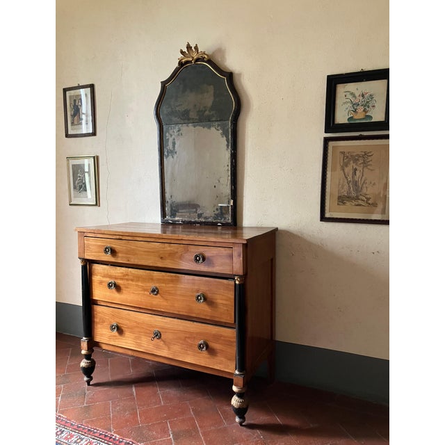 An exceptional early 19th-century Italian Empire cherrywood chest of drawers, masterfully crafted in Lucca (Tuscany)...