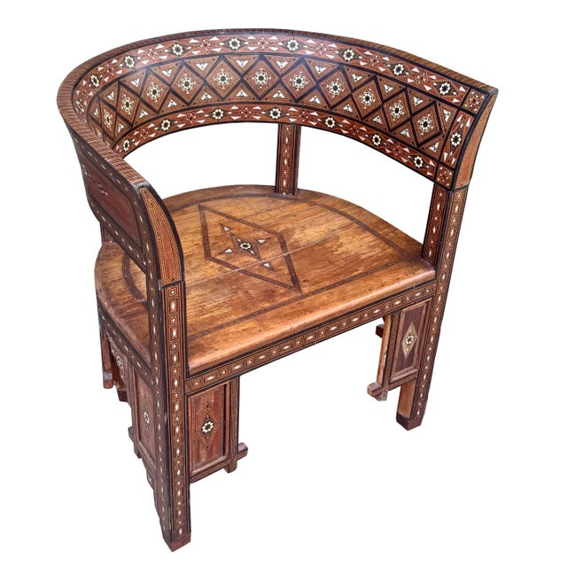 A finely crafted antique round-back chair made in Damascus, Syria, showcasing intricate marquetry wood inlay, beautifully...