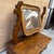 Charming antique dressing mirror in solid wood, mounted on a small storage box with a drawer on the front. The mirror is...