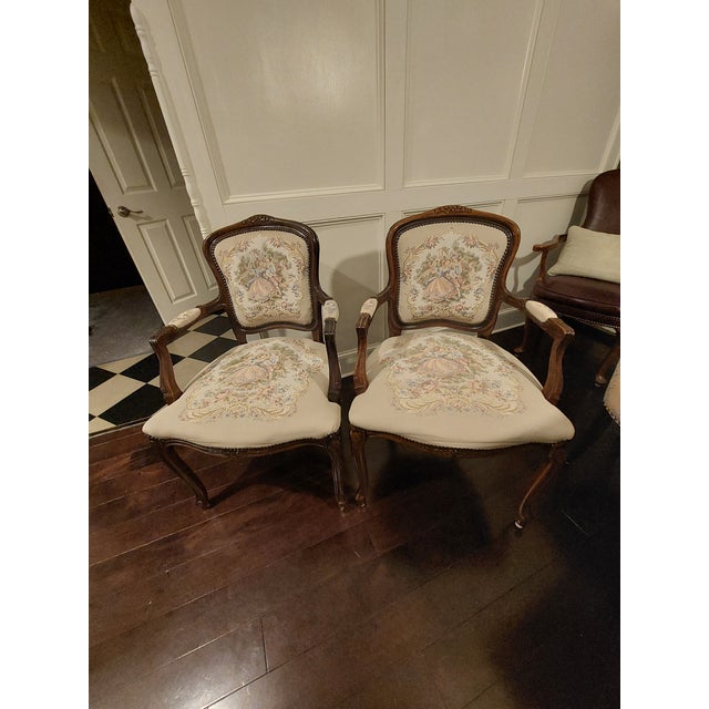 Sold as a pair • Louis XV-inspired / French Provincial style • Carved wood frames • Cabriole legs • Floral tapestry-style...